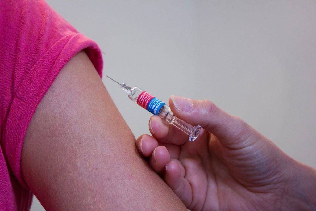 Vaccine being administered into a patient's arm